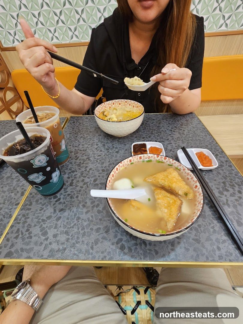 People eating noodles and drinks