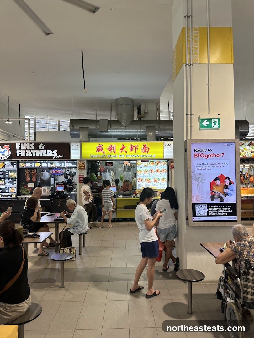 Food court with various stalls and patrons