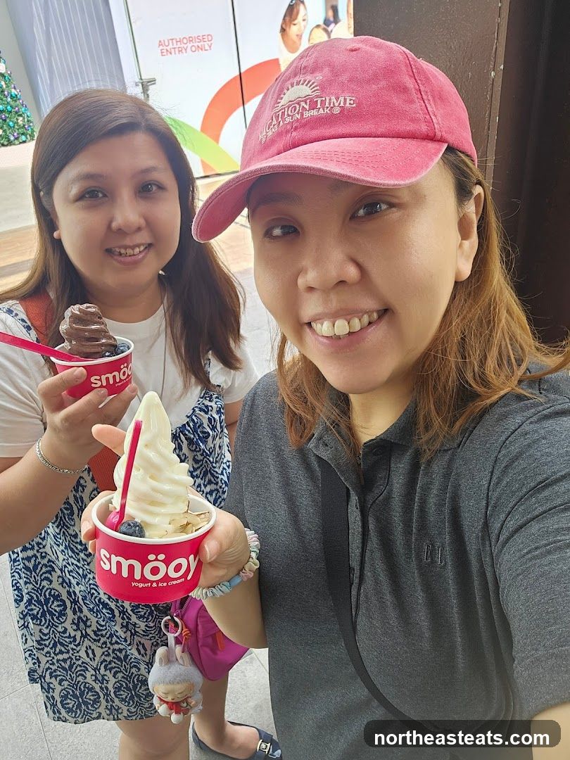 Two women holding ice cream cups