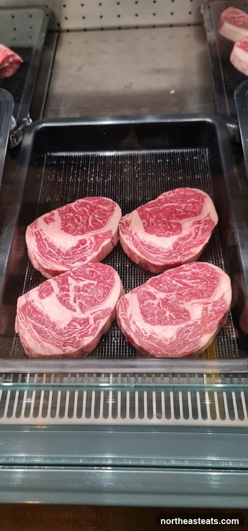 Four prime rib steaks on display