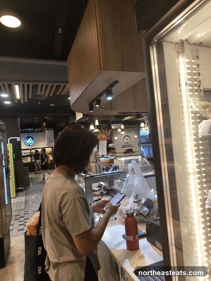 Customer using phone at counter