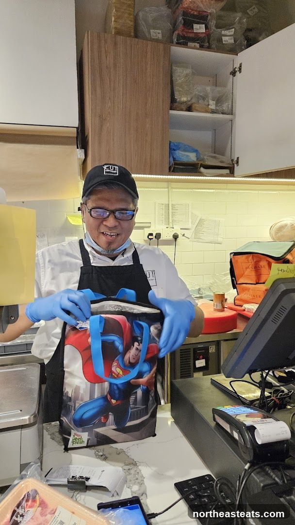 Butcher with Superman Bag