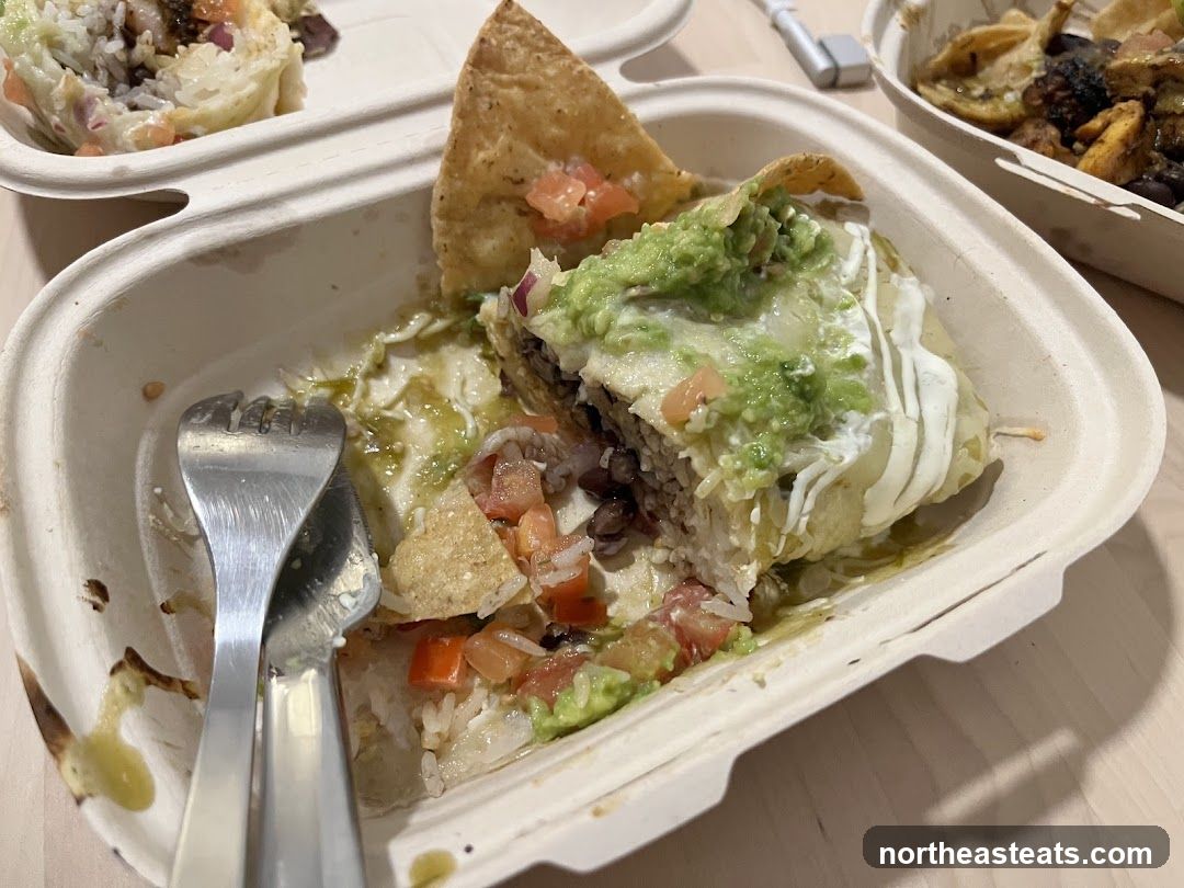 Partially Eaten Burrito with Guacamole and Sour Cream