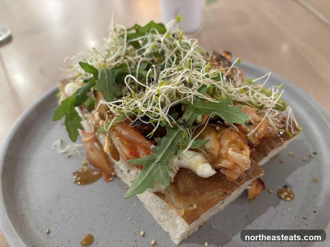 Open-faced sandwich with sprouts and kimchi