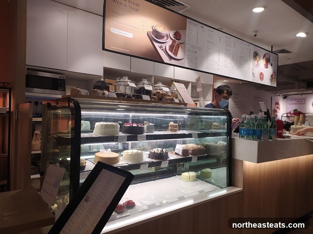 Cafe Interior with Cakes and Menu