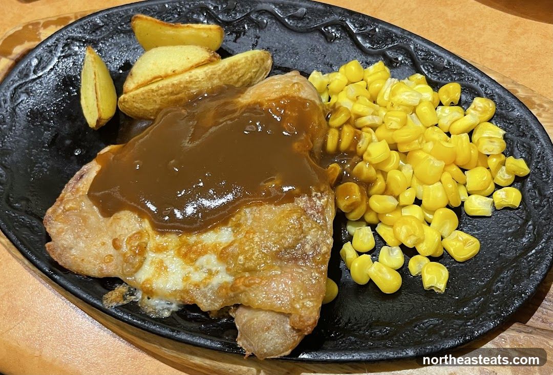 Chicken steak with corn and potato wedges
