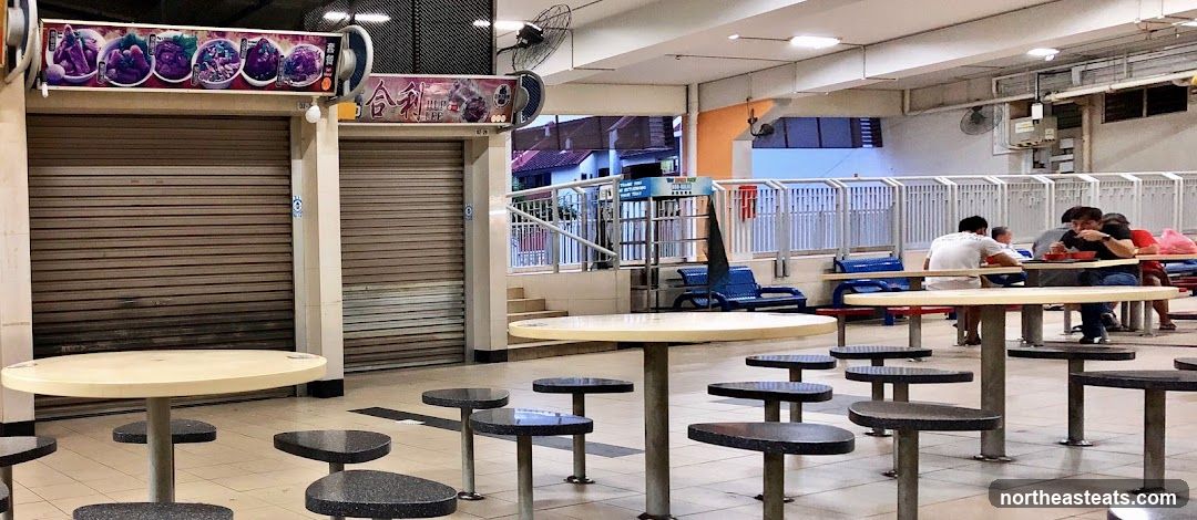 Food court with closed stalls and diners