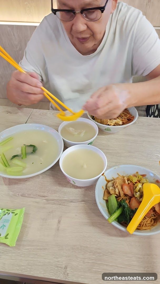Person eating noodles