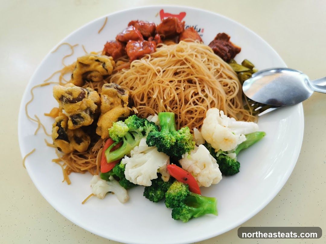 Plate of noodles with meat and vegetables