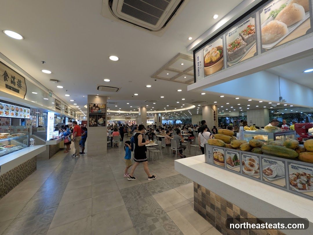 Food court with various stalls and seating areas