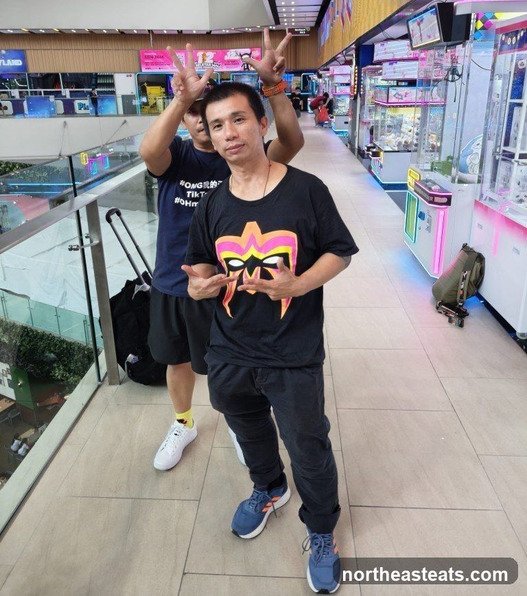 Two men posing in an arcade