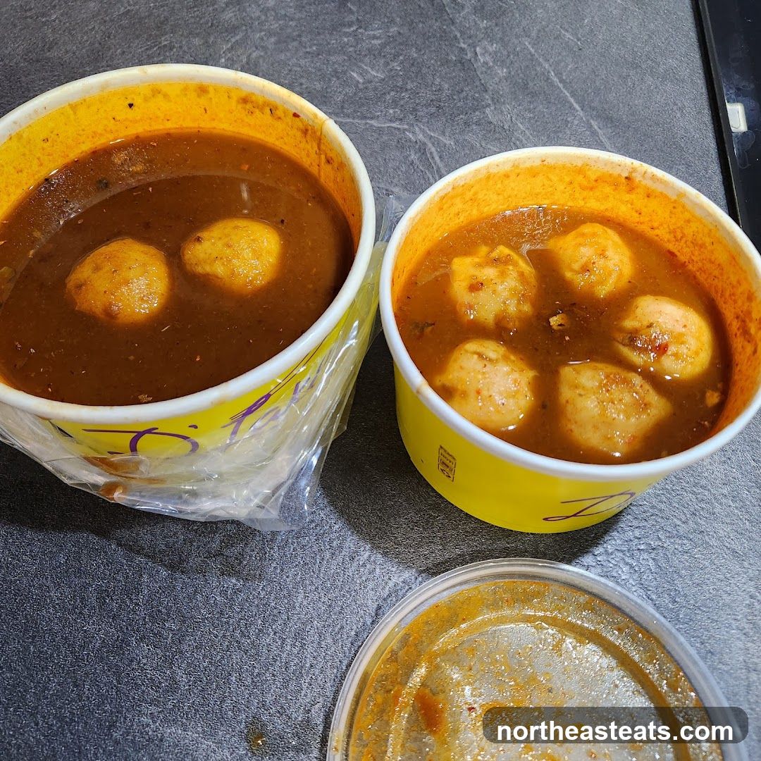 Two bowls of soup with meatballs