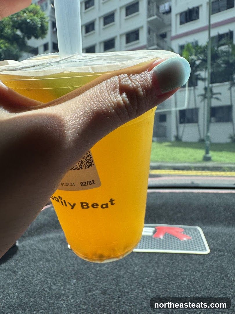 Orange Drink with "Daily Beat" Logo