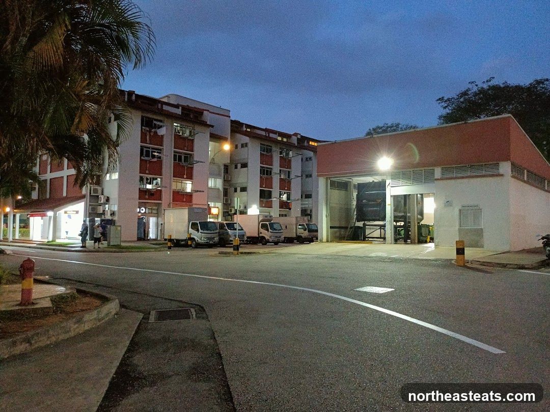 Industrial building with trucks at dusk