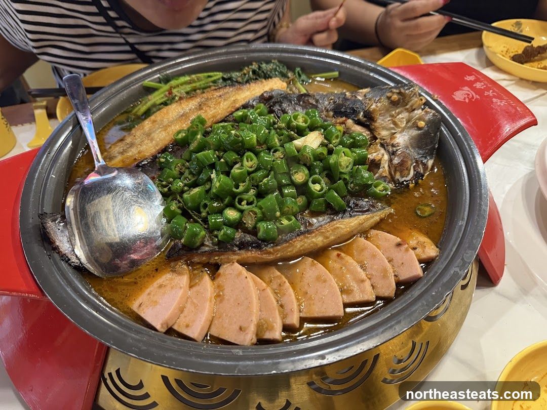 Fish dish with sliced peppers and sausage