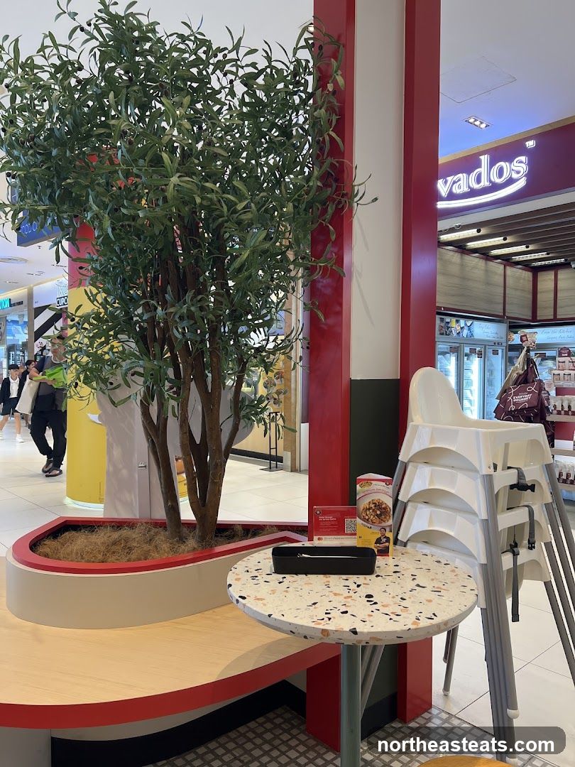 Restaurant Seating Area with Plant and High Chairs