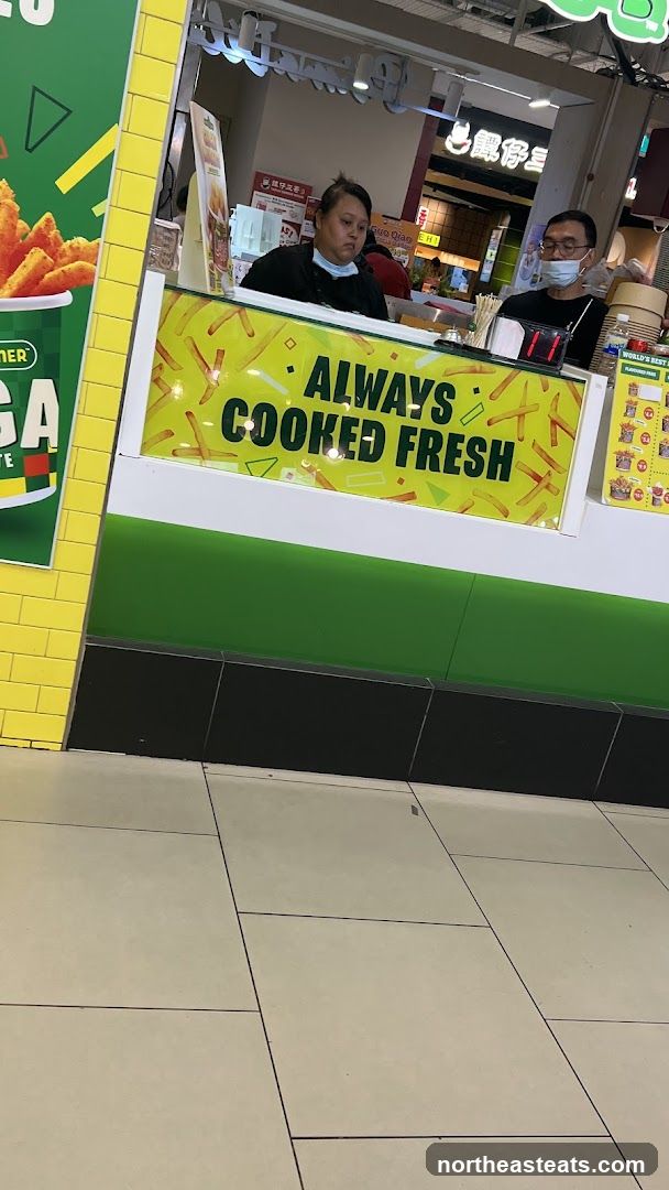 Food stall with "Always Cooked Fresh" sign