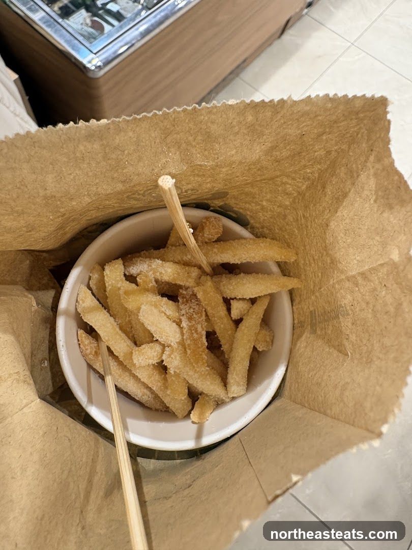 Sugar-dusted fries in a paper bag