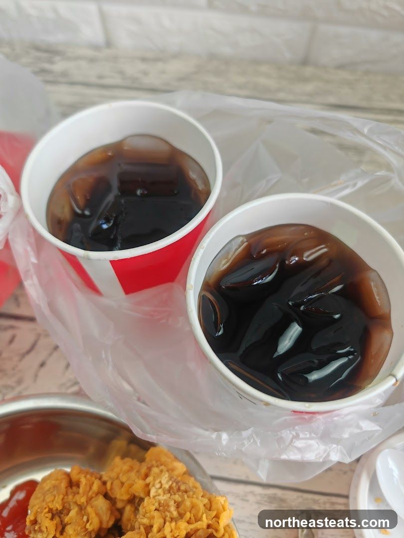 Two cups of cola with ice