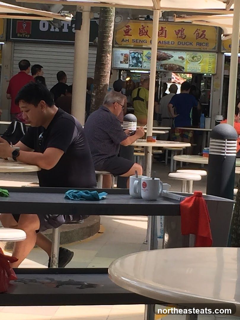 People eating at a food stall