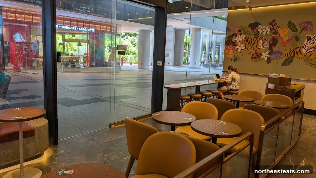 Interior of a cafe with seating and a mural