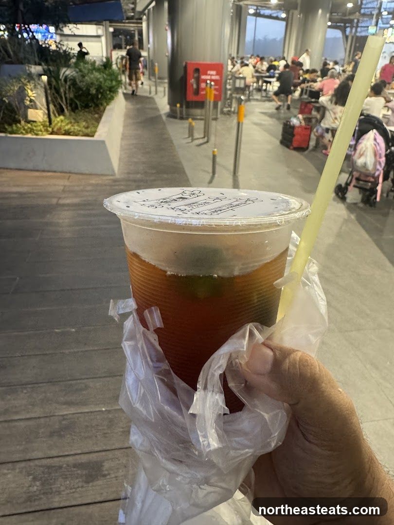 Person holding a drink in a plastic bag