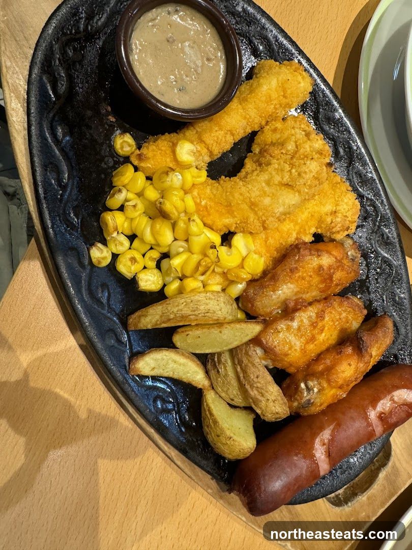 Platter of Fried Chicken Strips, Chicken Wings, Sausage, Potato Wedges, Corn, and Dip