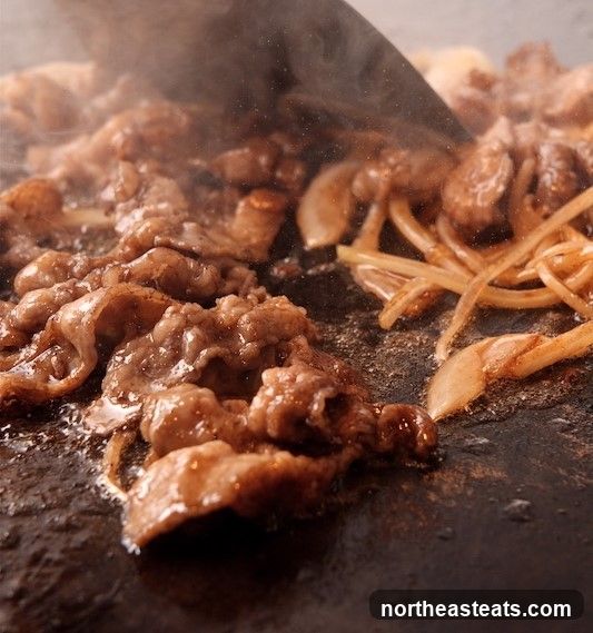 Sizzling Beef and Onions on a Griddle