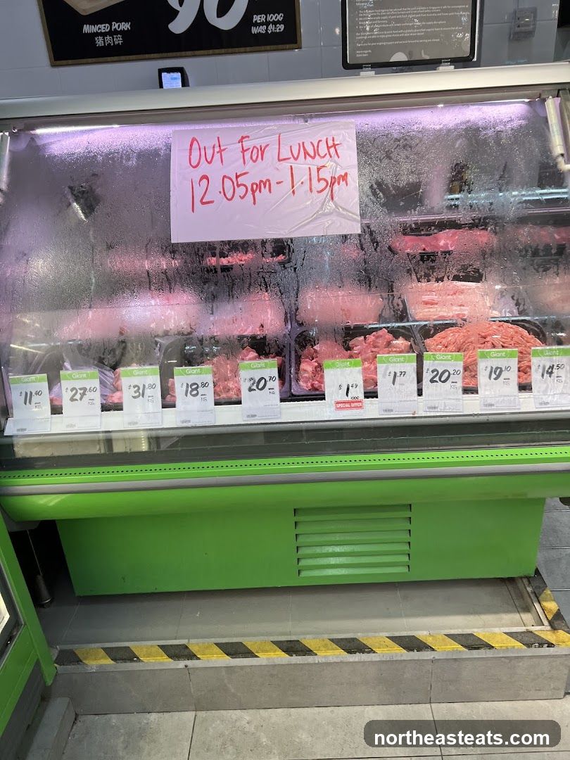 Meat display with lunch break sign