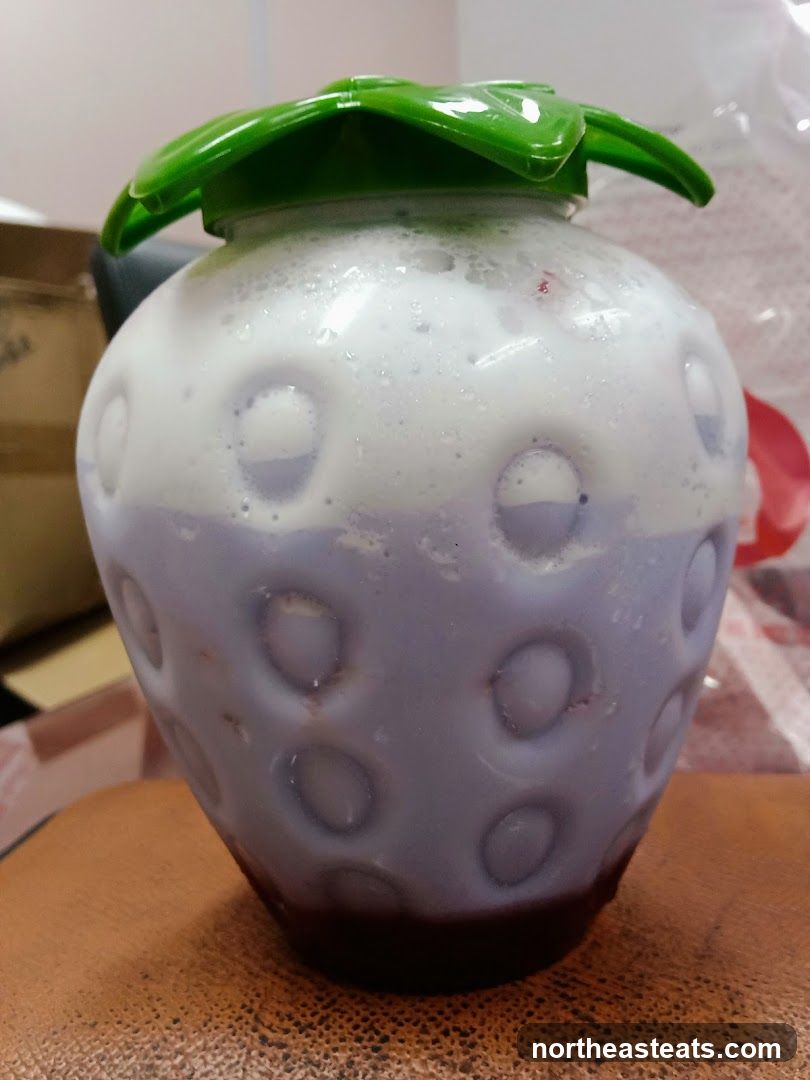 Strawberry-shaped cup with drink