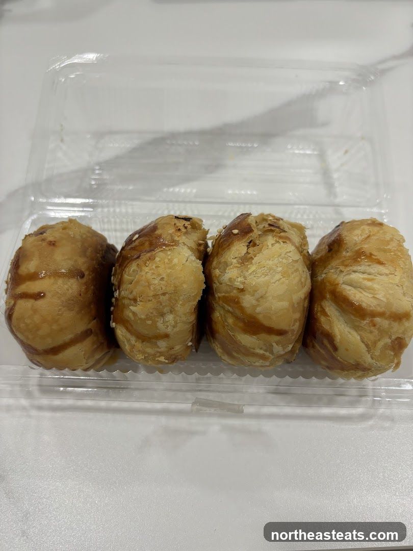 Four pastries in a clear plastic container