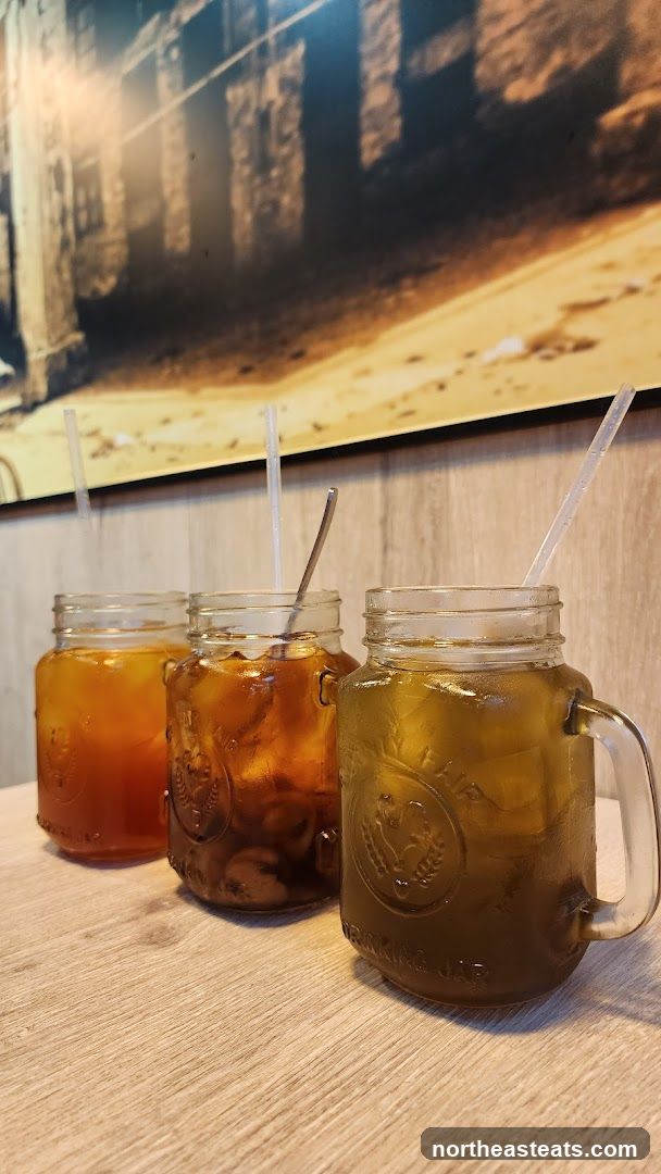 Three iced drinks in mason jars