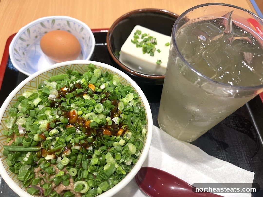 Donburi with toppings, egg, tofu, and drink
