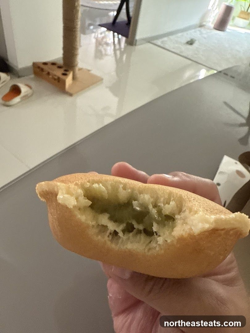 Close-up of a half-eaten pancake with green filling