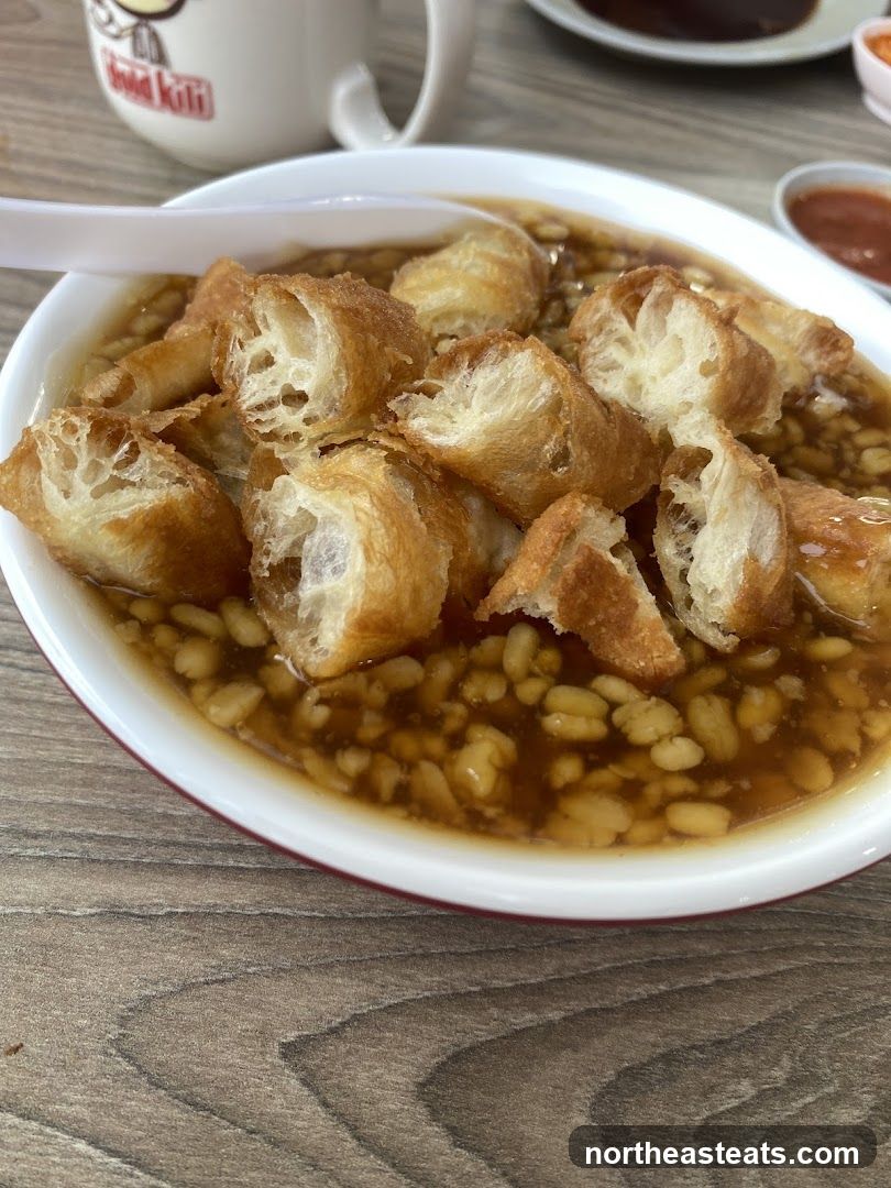 Bowl of Sweet Soup with Fried Dough Sticks