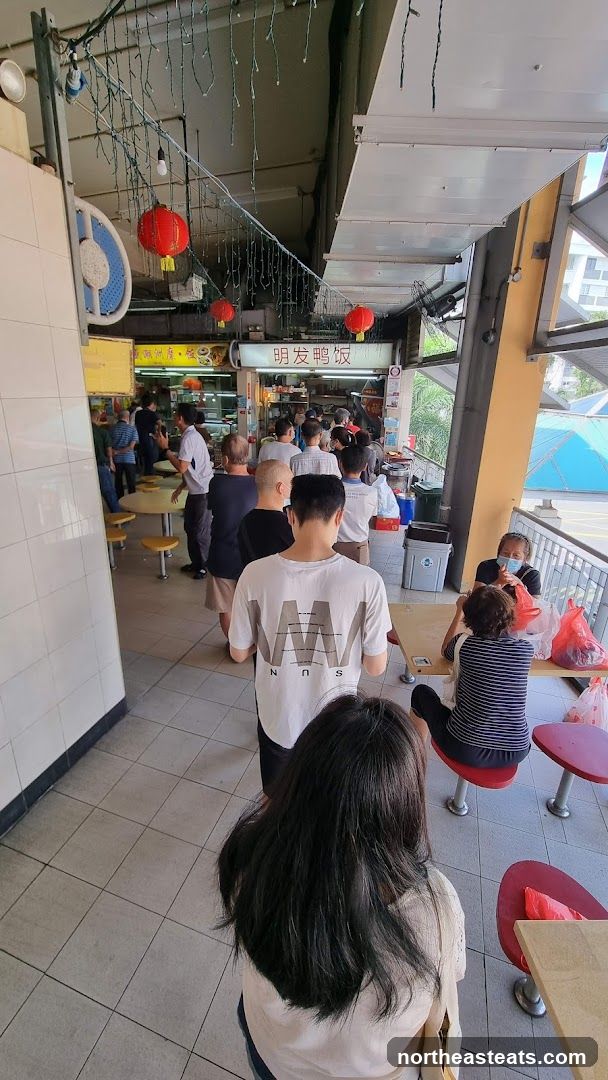 Busy food stall with a long queue