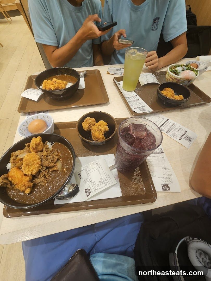 People Eating Curry Rice and Drinks