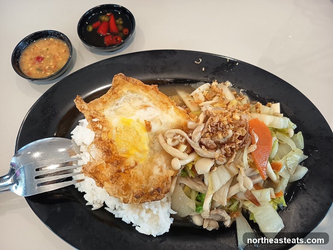 Stir-fried vegetables with rice and fried egg
