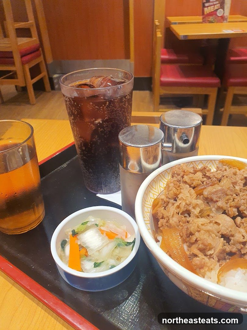 Beef bowl with side dishes and drink