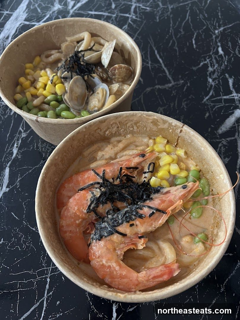 Two bowls of seafood noodles