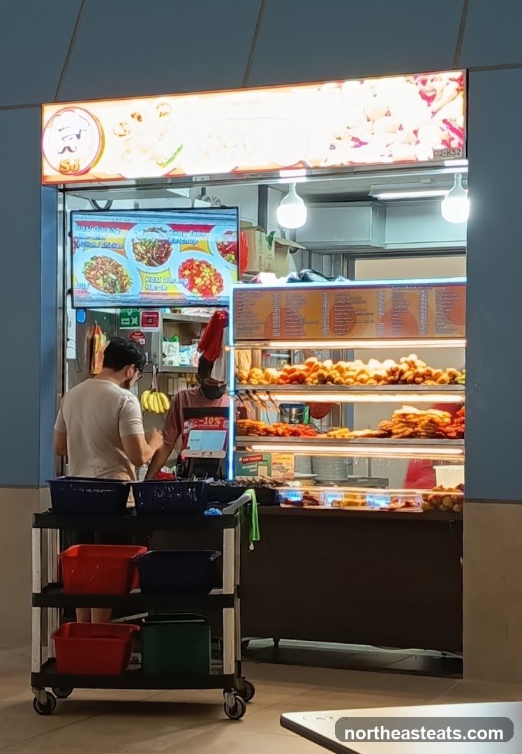 Food stall with displayed menu and fried items