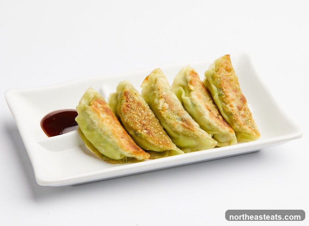Pan-fried dumplings with dipping sauce