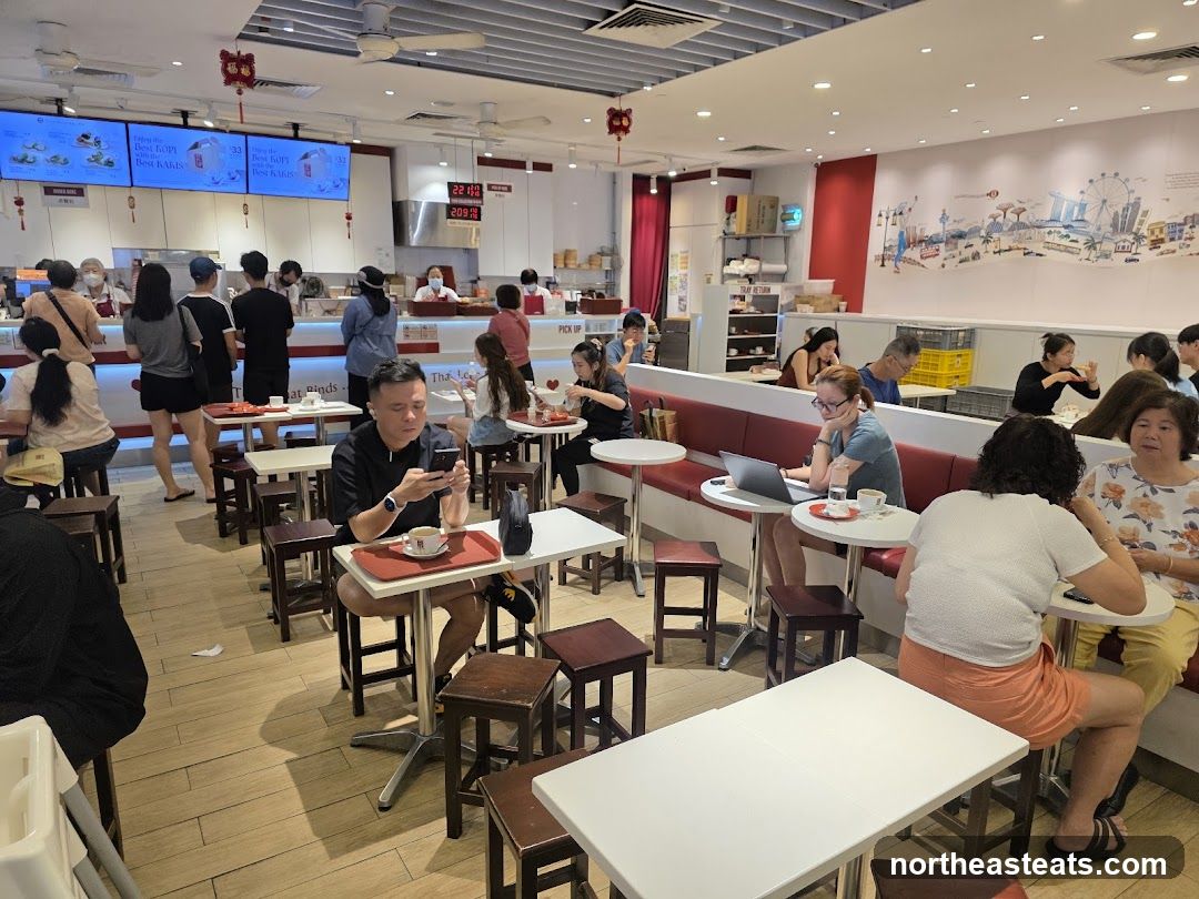 Busy cafe interior with customers dining and ordering