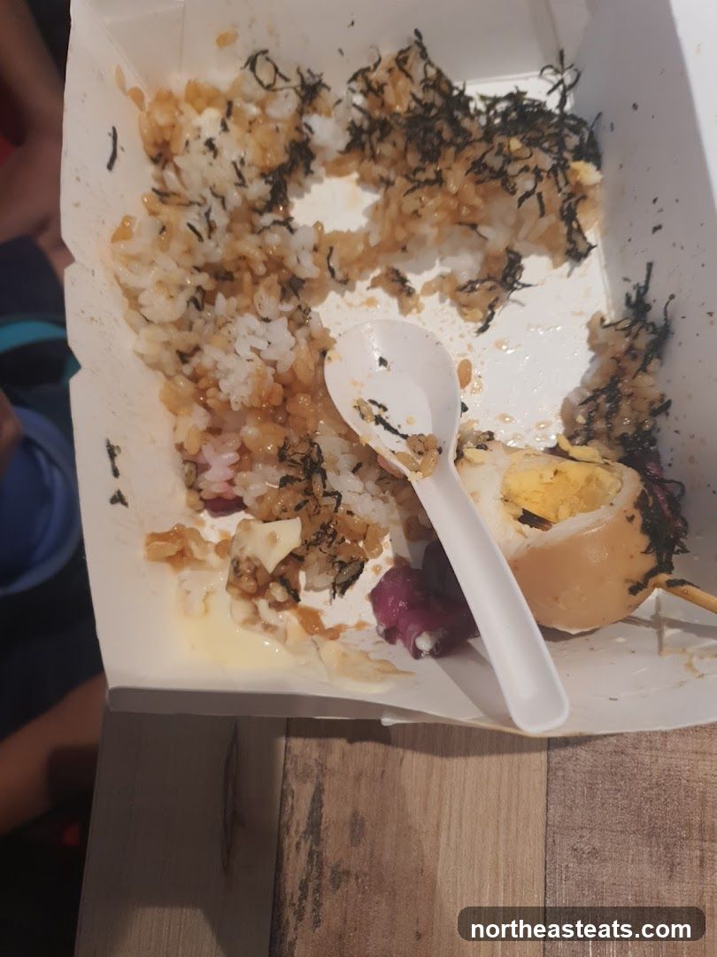 Partially Eaten Rice Bowl with Egg and Octopus