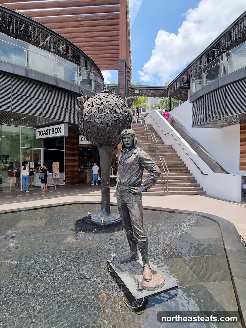Outdoor Plaza with Statue and Shops