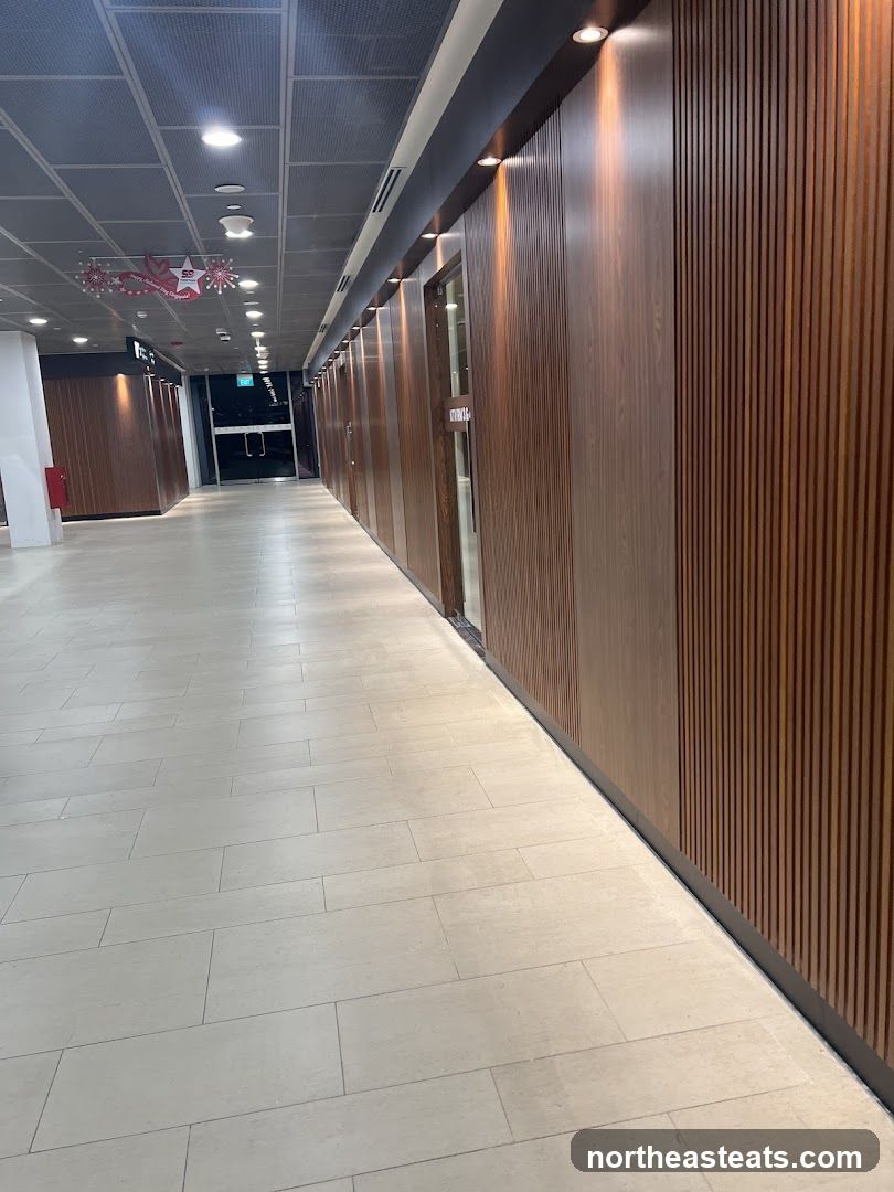 Hallway with wooden paneling and tiled floor