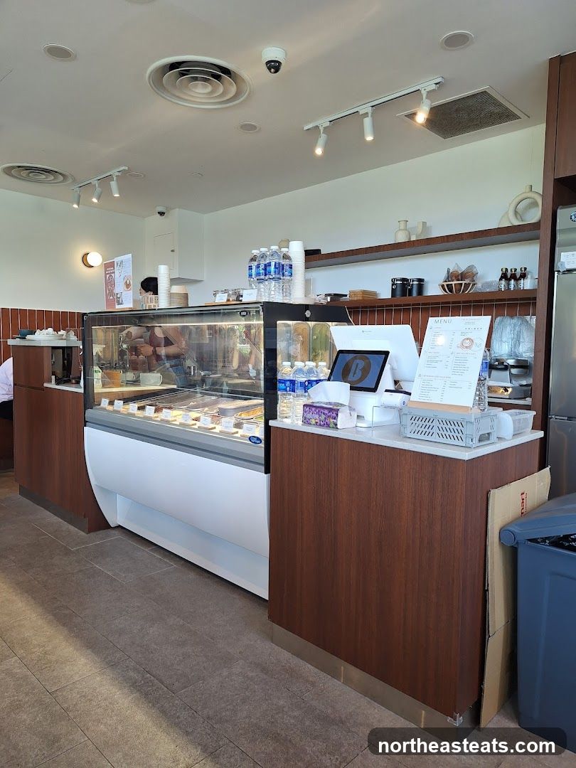 Dessert shop counter with display case and menu