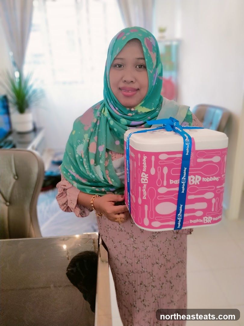 Woman holding an ice cream cake container