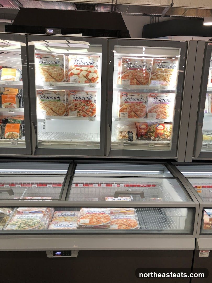 Frozen Pizzas in a Supermarket Freezer