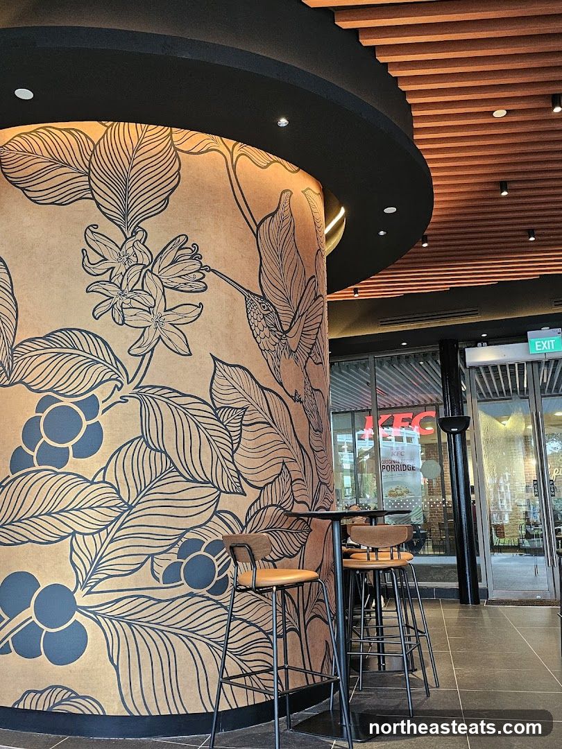 Interior of a cafe with decorative pillar and view of KFC